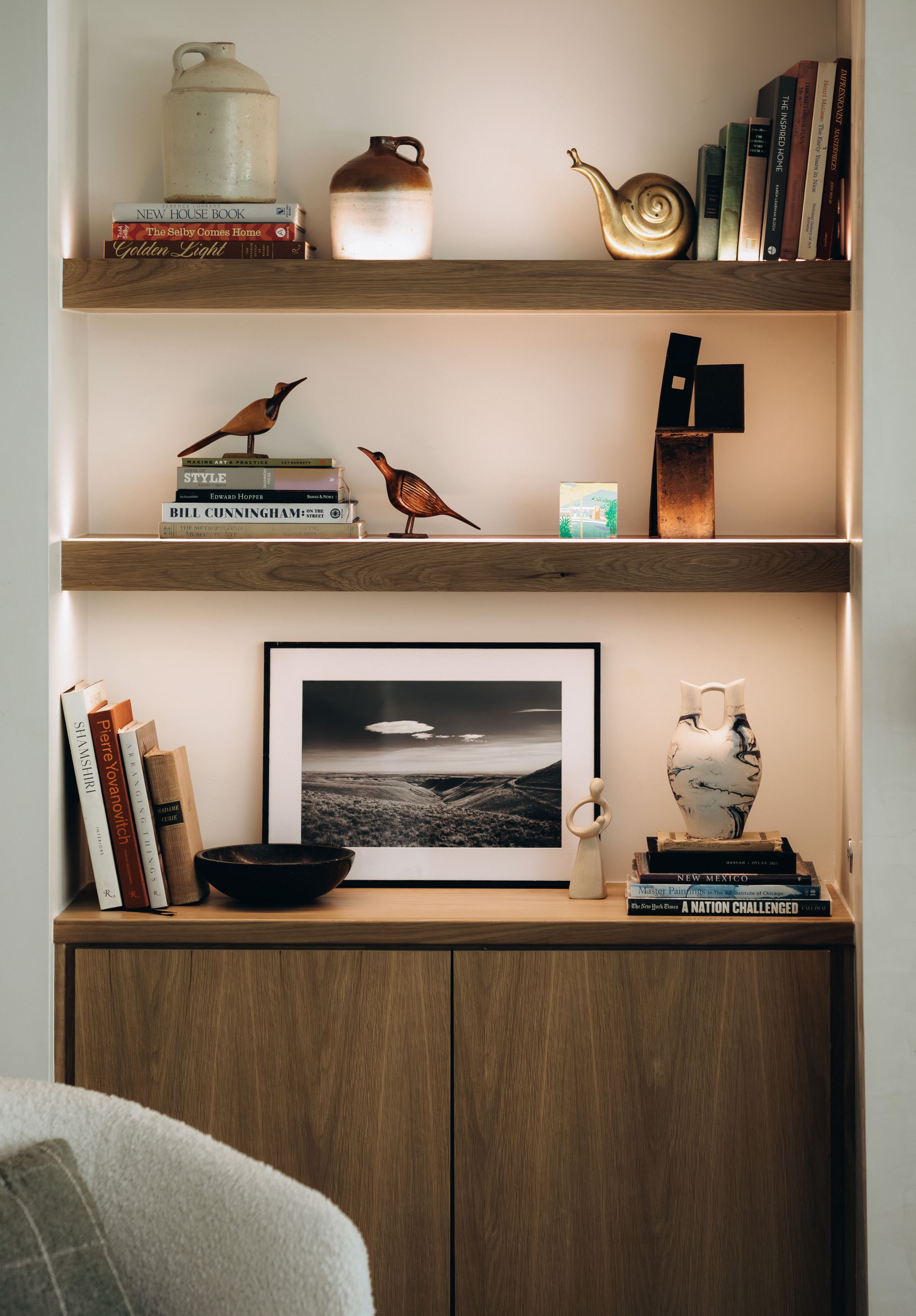 Styled bookshelf vignette with ceramic vases and sculptural objects