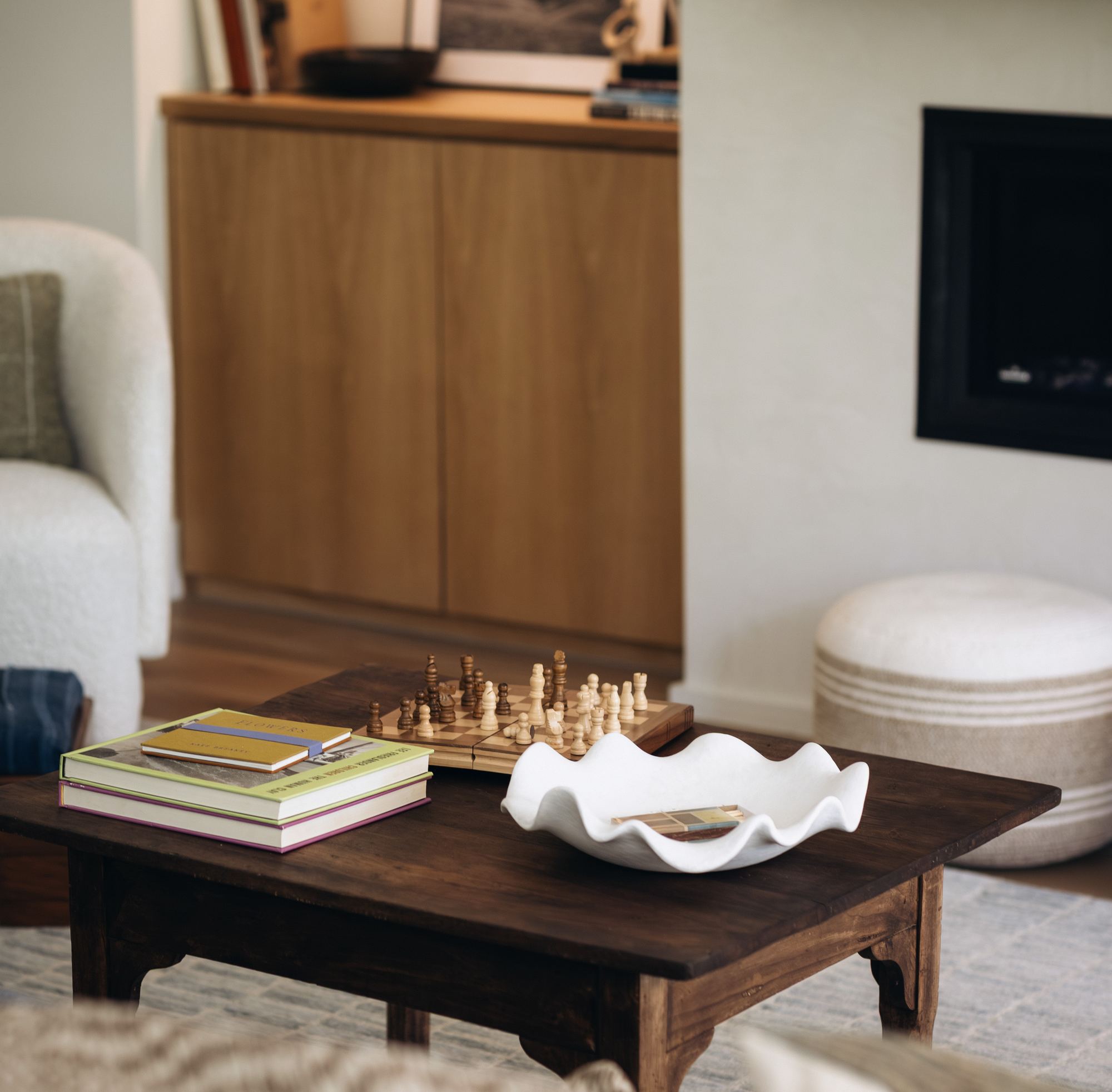 Coffee table styling with a chess set and sculptural bowl