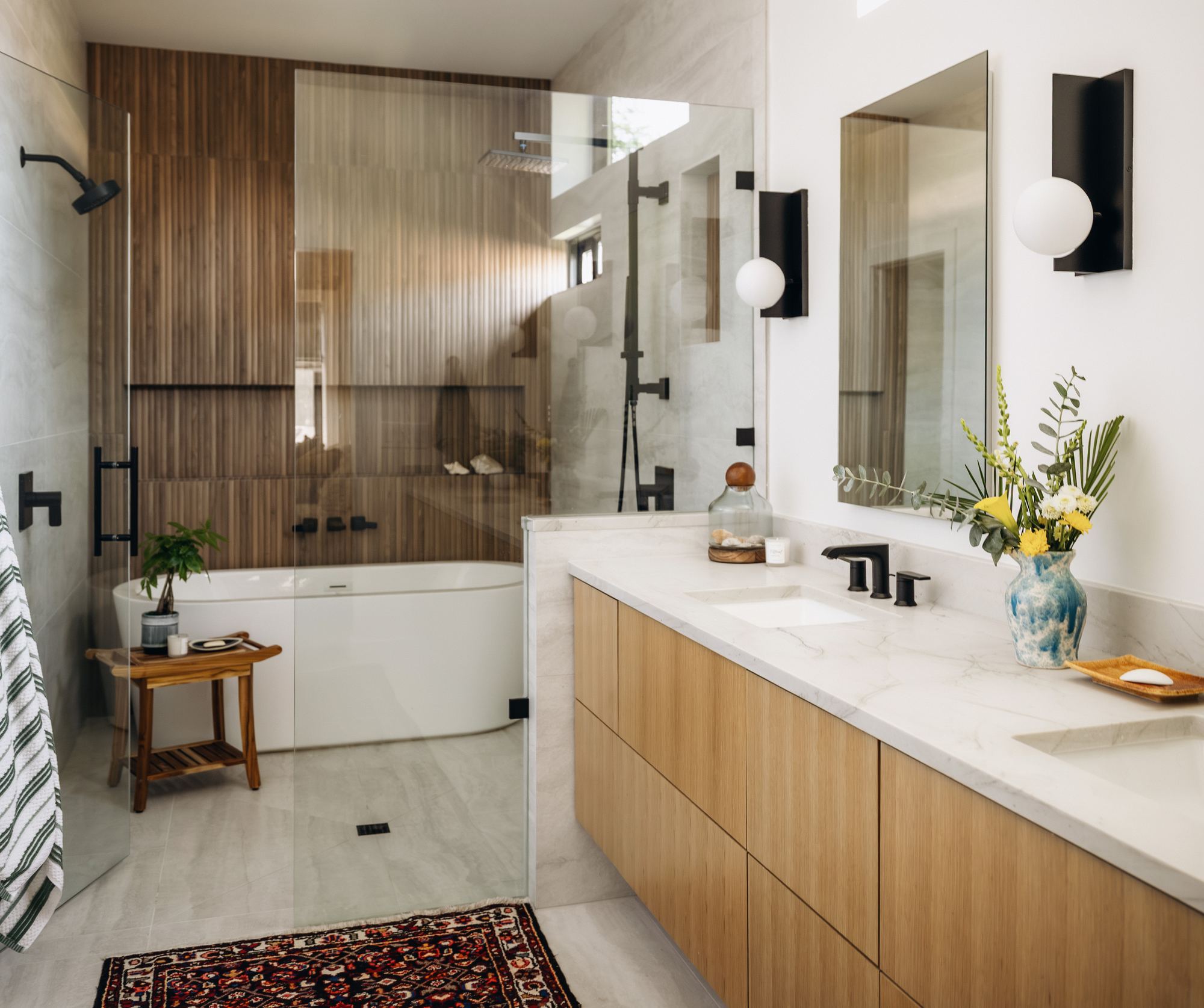 Primary bathroom with a freestanding tub and glass-enclosed shower