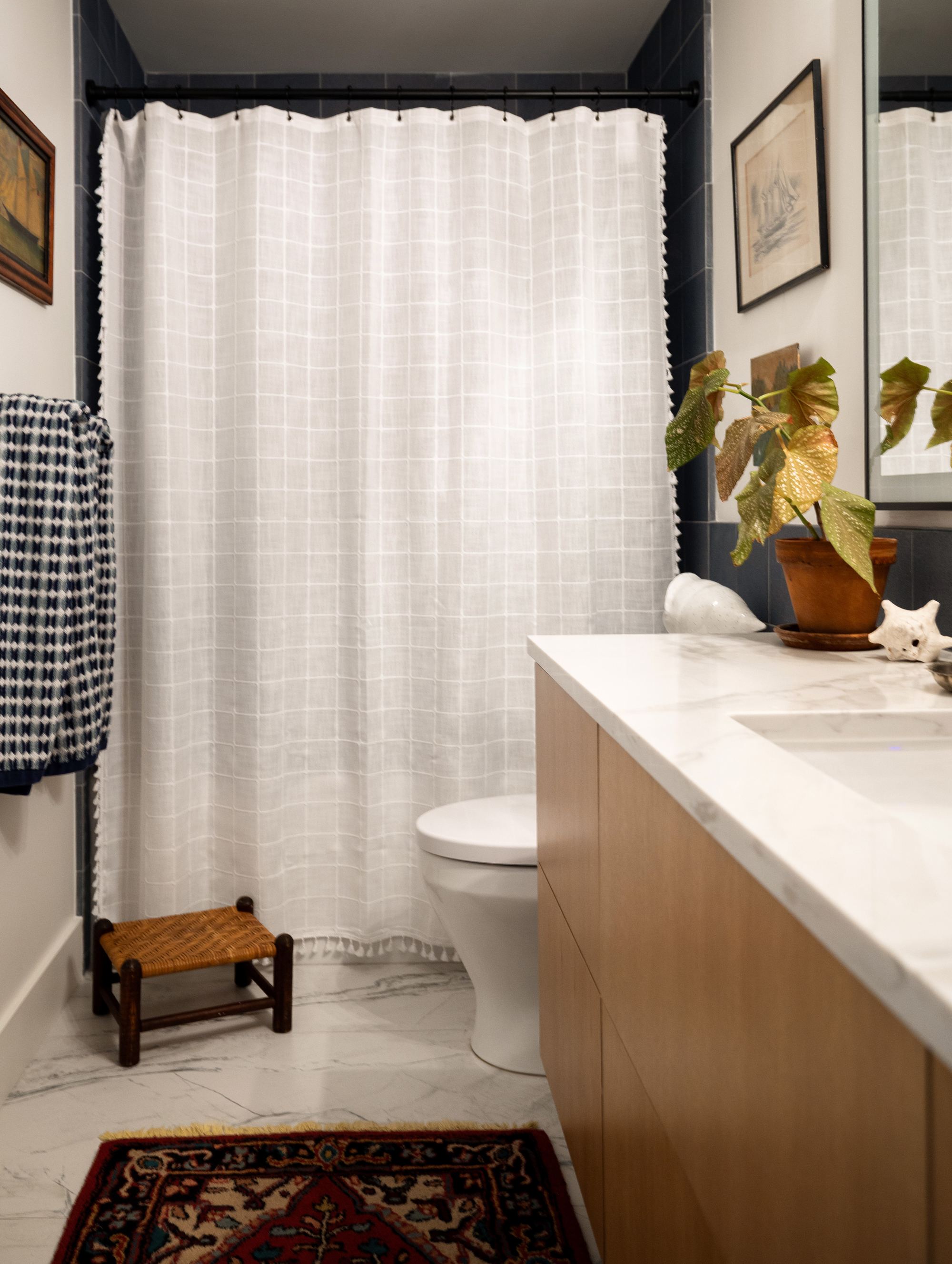 Secondary bathroom with a marble vanity and vintage rug