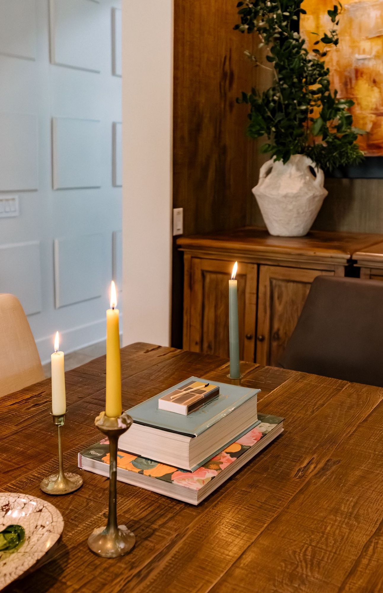 Dining table styling with candlelight and a plaster vase