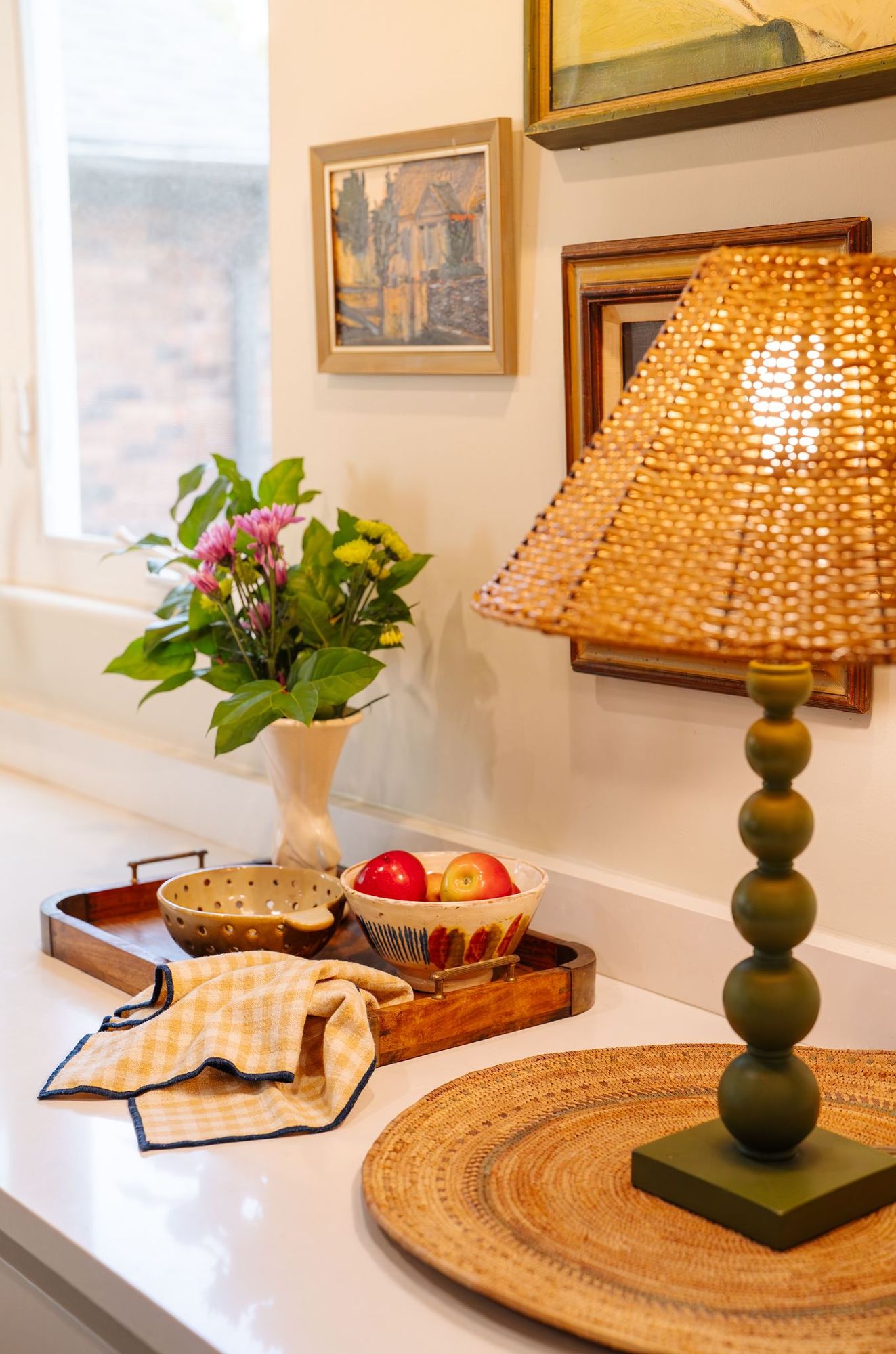 Kitchen counter styling with fresh flowers and vintage framed art