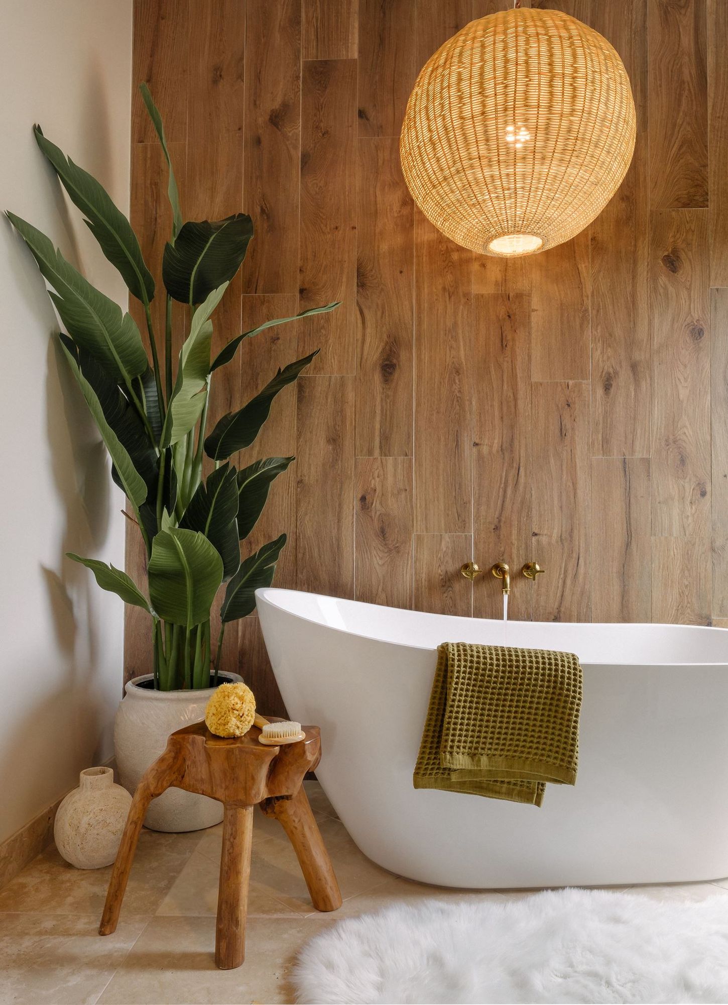 Primary bathroom with a woven pendant light and freestanding tub
